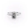 2 carat oval moissanite engagement ring in white gold angled side view showing slim band and pear accent cluster (2)