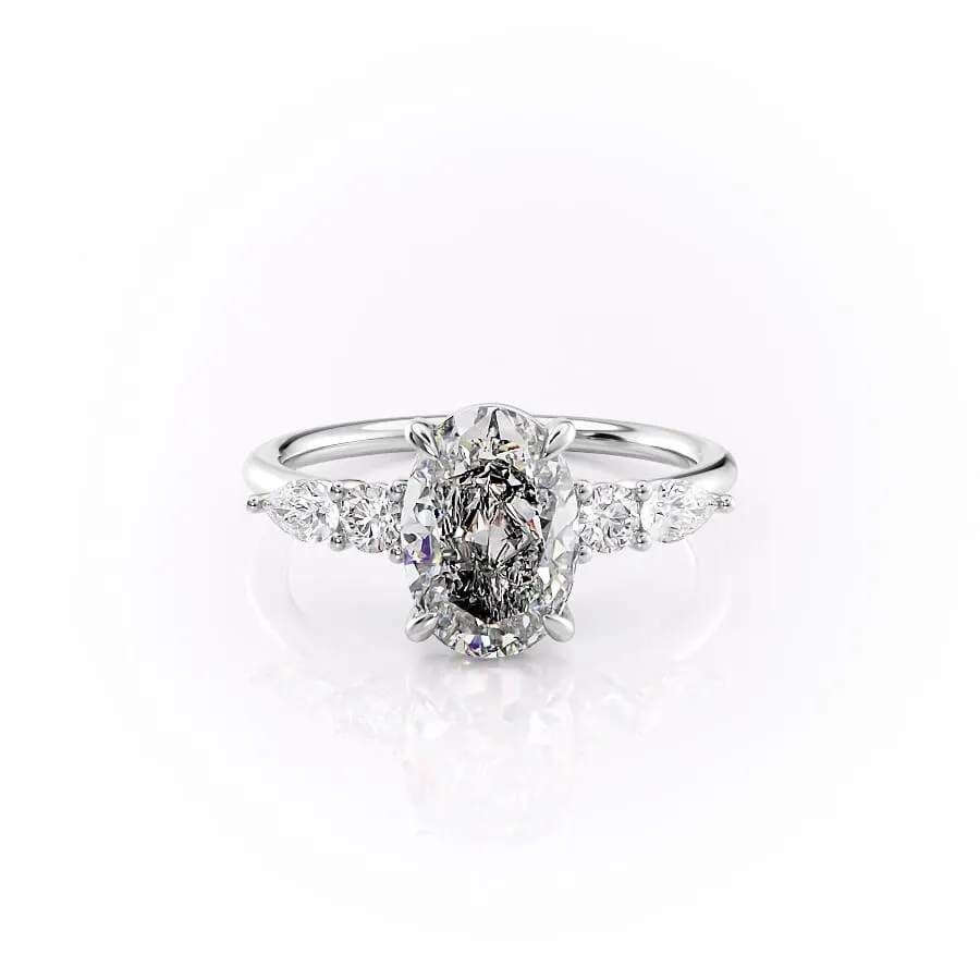 2 carat oval moissanite engagement ring in white gold angled side view showing slim band and pear accent cluster (2)