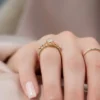2 carat oval moissanite engagement ring in yellow gold rear view showing open basket claw setting and slim polished band