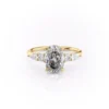 2 carat oval moissanite engagement ring worn on hand in yellow gold showing cluster side stones and slim band lifestyle view (2)_1