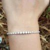 2.5 Ct graduated moissanite tennis bracelet in 14K gold in Wrist