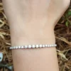 2.5 Ct graduated moissanite tennis bracelet in 18K gold in Wrist