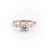 4 ct round diamond engagement ring in Rose gold angled side view showing slim band and staggered pear and round cluster shoulders