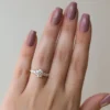 4 ct round diamond engagement ring in rose gold worn on hand lifestyle view showing cluster side stones and slim band