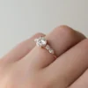 4 ct round diamond engagement ring in white gold front view showing round brilliant moissanite centre and symmetrical side stone clusters