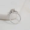 4 ct round diamond engagement ring in white gold front view showing round brilliant moissanite centre and symmetrical side stone clusters