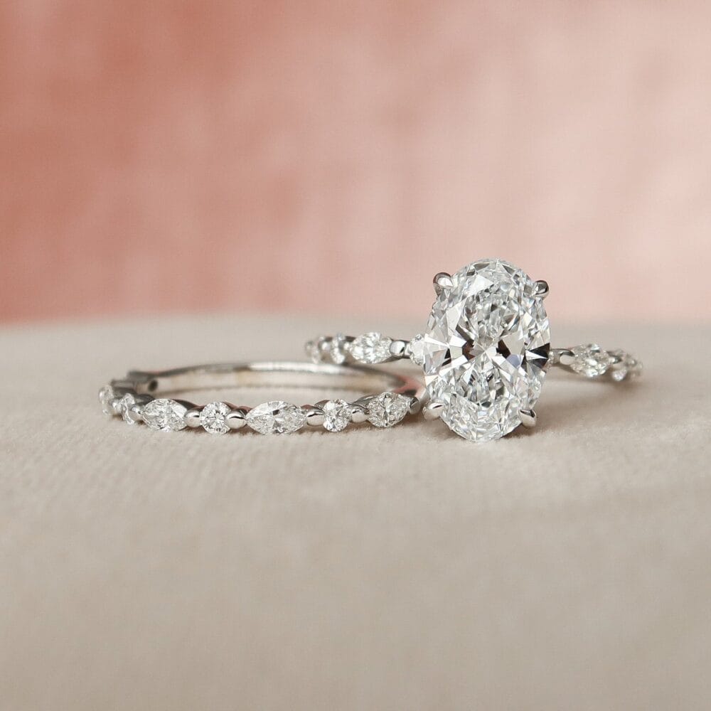 Oval Engagement Ring with Wedding Band Set for Women , A 2.5CT oval cut moissanite engagement ring set, featuring a large oval center stone and a matching wedding band with marquise-cut diamonds.