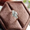 A 3 Ct cushion cut engagement ring displayed on a brown box, emphasizing its elegance and the allure of its diamond cut