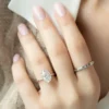 The Seraphina | Hidden Halo Oval Moissanite Engagement Ring A beautiful 14K white gold hidden halo oval moissanite engagement ring on a finger