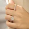 The Seraphina | Hidden Halo Oval Moissanite Engagement Ring A beautiful 14K white gold hidden halo oval moissanite engagement ring on a finger