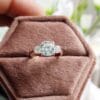 A cushion cut diamond engagement ring displayed elegantly in an open box symbolizing love and commitment