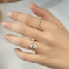 The Seraphina | Hidden Halo Oval Moissanite Engagement Ring A sparkling 14K yellow gold hidden halo oval moissanite engagement ring
