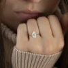 The Seraphina | Hidden Halo Oval Moissanite Engagement Ring A sparkling 14K yellow gold hidden halo oval moissanite engagement ring