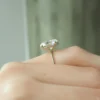 The Seraphina | Hidden Halo Oval Moissanite Engagement Ring A sparkling 14K yellow gold hidden halo oval moissanite engagement ring