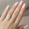 The Seraphina | Hidden Halo Oval Moissanite Engagement Ring A sparkling 14K yellow gold hidden halo oval moissanite engagement ring