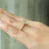 The Seraphina | Hidden Halo Oval Moissanite Engagement Ring A sparkling 14K yellow gold hidden halo oval moissanite engagement ring