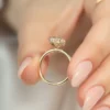 The Seraphina | Hidden Halo Oval Moissanite Engagement Ring A sparkling 14K yellow gold hidden halo oval moissanite engagement ring
