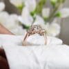 A stunning cushion cut engagement ring in rose gold, resting gracefully on a pristine white cloth, highlighting its elegance