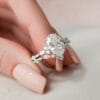 A woman's hand elegantly displays a vintage oval diamond engagement ring, showcasing its timeless beauty