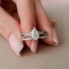 A woman's hand holds a stunning diamond engagement ring wedding band set, representing a promise of everlasting love.