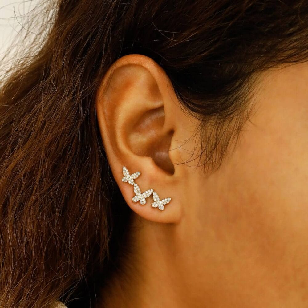 Adorn yourself with these 14K Gold Butterfly Trio Climber Earrings, featuring pavé moissanite stones that add subtle sparkle to any look. A must-have for daily elegance