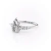 Close-up of pear cut gemstone ring showing round and pear-shaped accent diamonds in white gold
