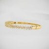 Enhance your jewelry collection with this Tapered Baguette Moissanite Bangle Bracelet, crafted in 14K gold. A piece of classic elegance perfect for any occasion.