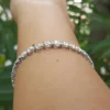 Graduated Tennis Bracelets | 14K Gold & Moissanite Luxury 14K gold graduated tennis bracelet on wrist