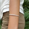 Graduated Tennis Bracelets | 14K Gold & Moissanite Luxury 14K gold graduated tennis bracelet on wrist