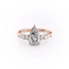 Pear shaped diamond wedding ring in rose gold with moissanite center stone and cluster side stones (1)