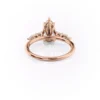 Pear shaped diamond wedding ring in rose gold with moissanite center stone and cluster side stones (10)