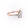 Pear shaped diamond wedding ring in rose gold with moissanite center stone and cluster side stones (7)