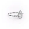 Pear shaped moissanite wedding ring with rose gold band and solitaire side stone cluster