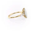 Side profile of large marquise moissanite ring in rose gold showing staggered pear and round cluster side stone arrangement