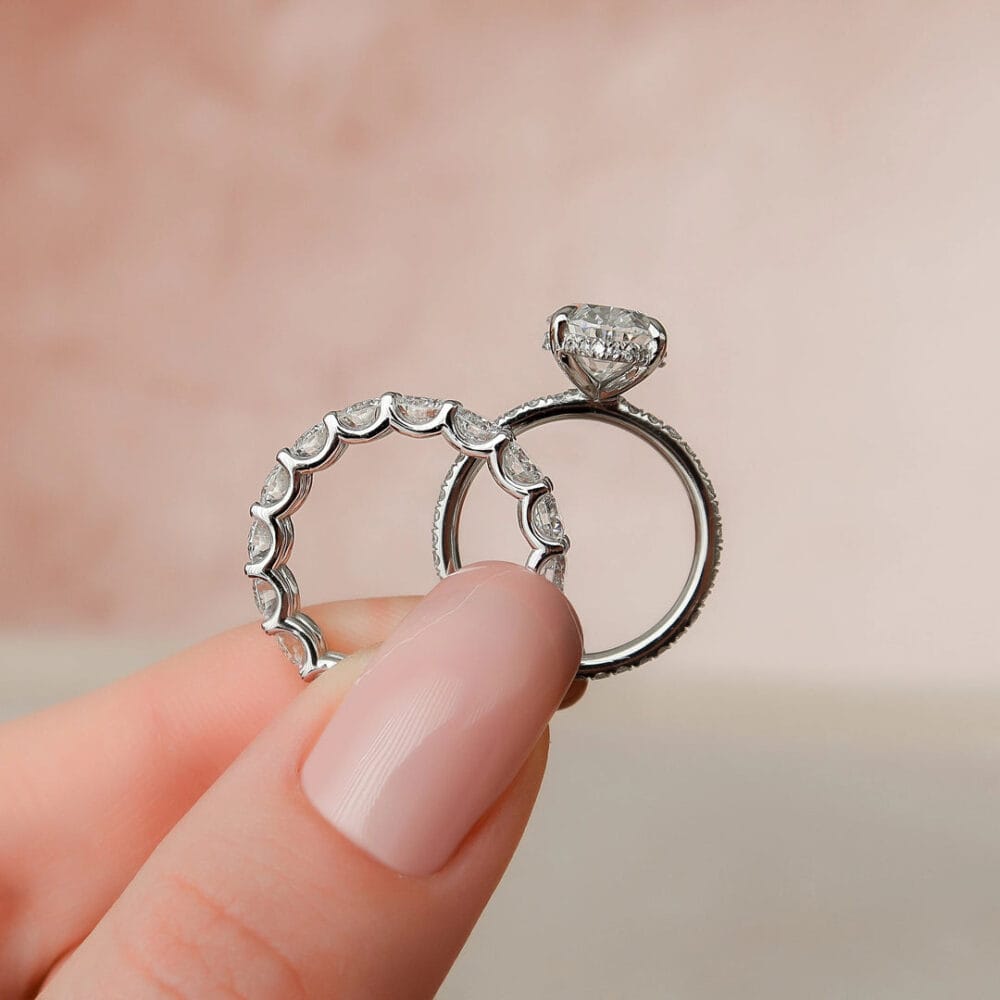 Two stunning 14K gold wedding rings with diamonds are held delicately in a hand With u prong Eternity Wedding Band