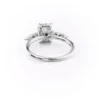 classic emerald cut moissanite engagement ring with round and pear accent cluster white gold angled view