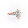 Rose gold 3 carat marquise moissanite engagement ring showing V-tip six claw setting and cluster shoulders