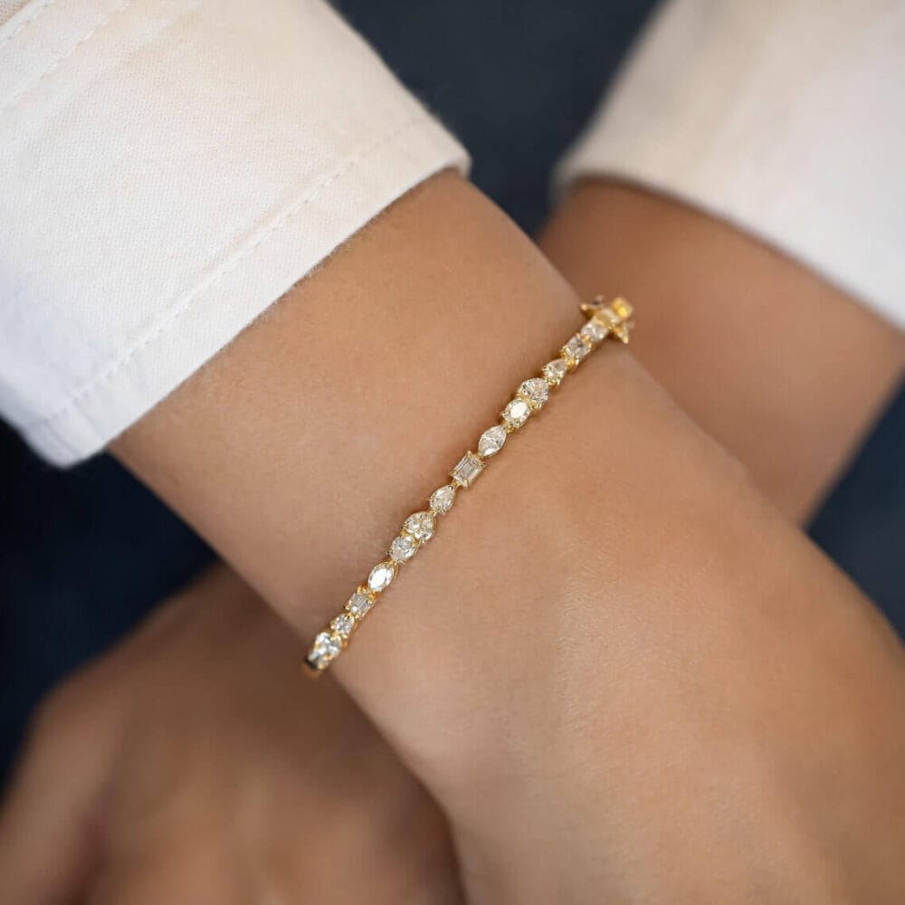 this 2.2Ct Multi-Shape Moissanite Diamond Bangle Bracelet, set in 14K solid gold. A stunning, versatile accessory for any elegant occasion.