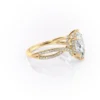 Sparkling yellow gold marquise diamond engagement ring with twisted band.