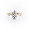 Sparkling yellow gold marquise diamond engagement ring with twisted band.